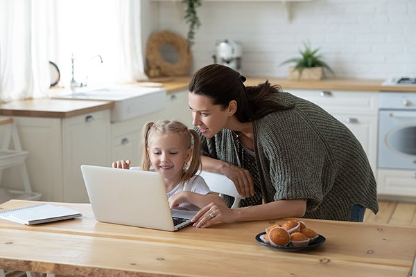 mother and child looking at laptop